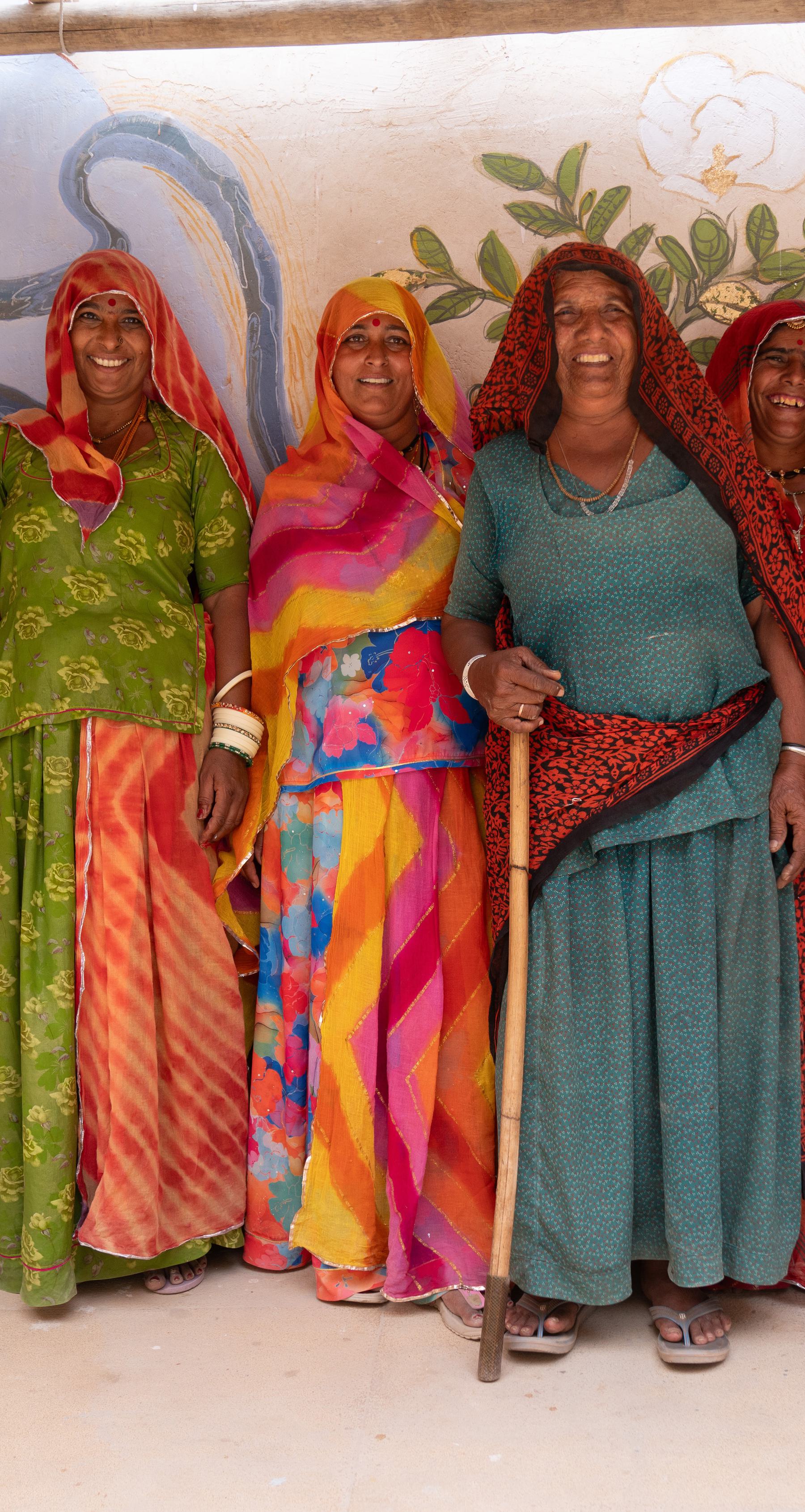 3 women dressed in color dresses