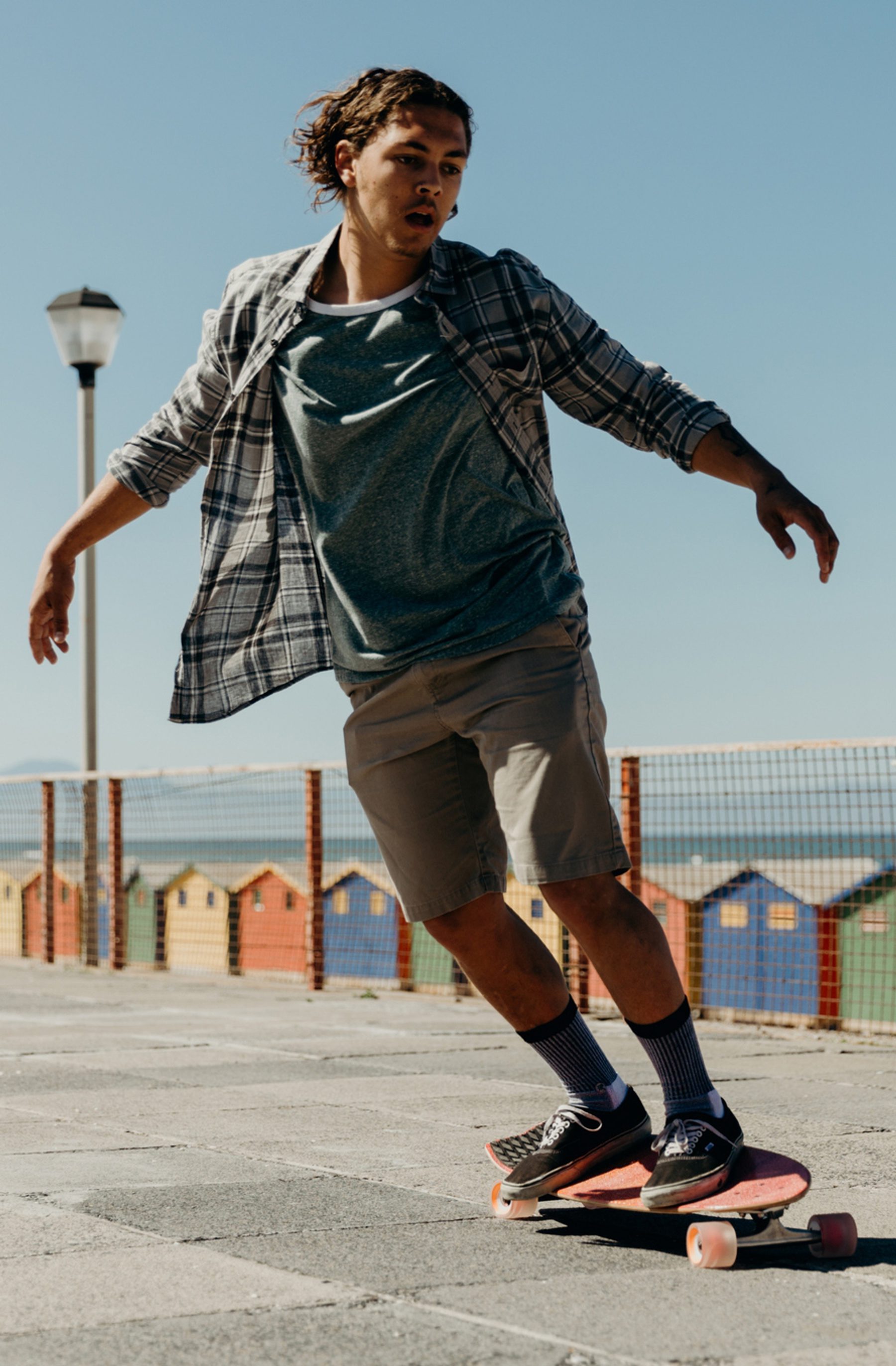 woman skateboarding on a paved street